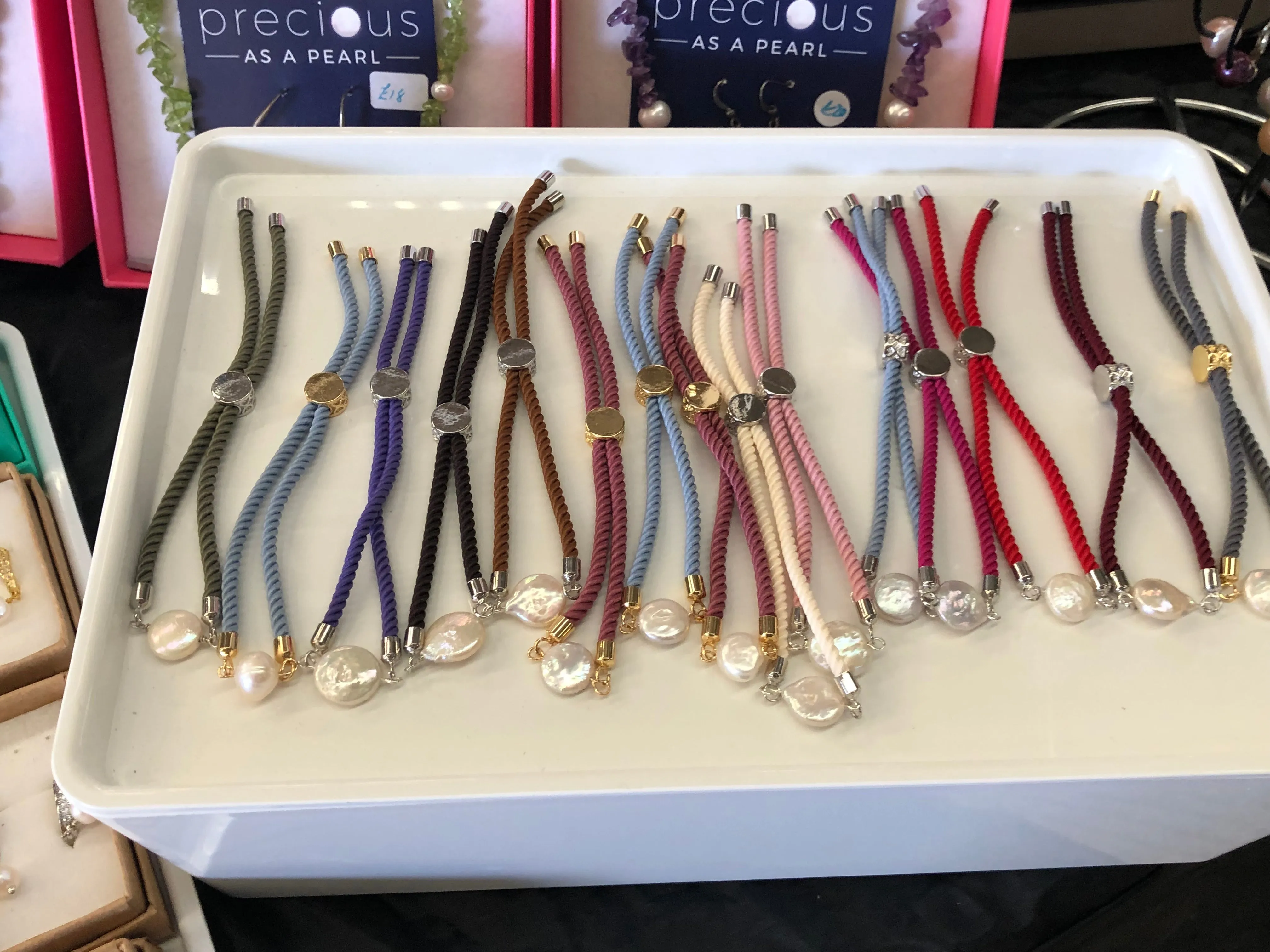 Bracelet: Pearl coin corded slider bracelets in goldtone.
