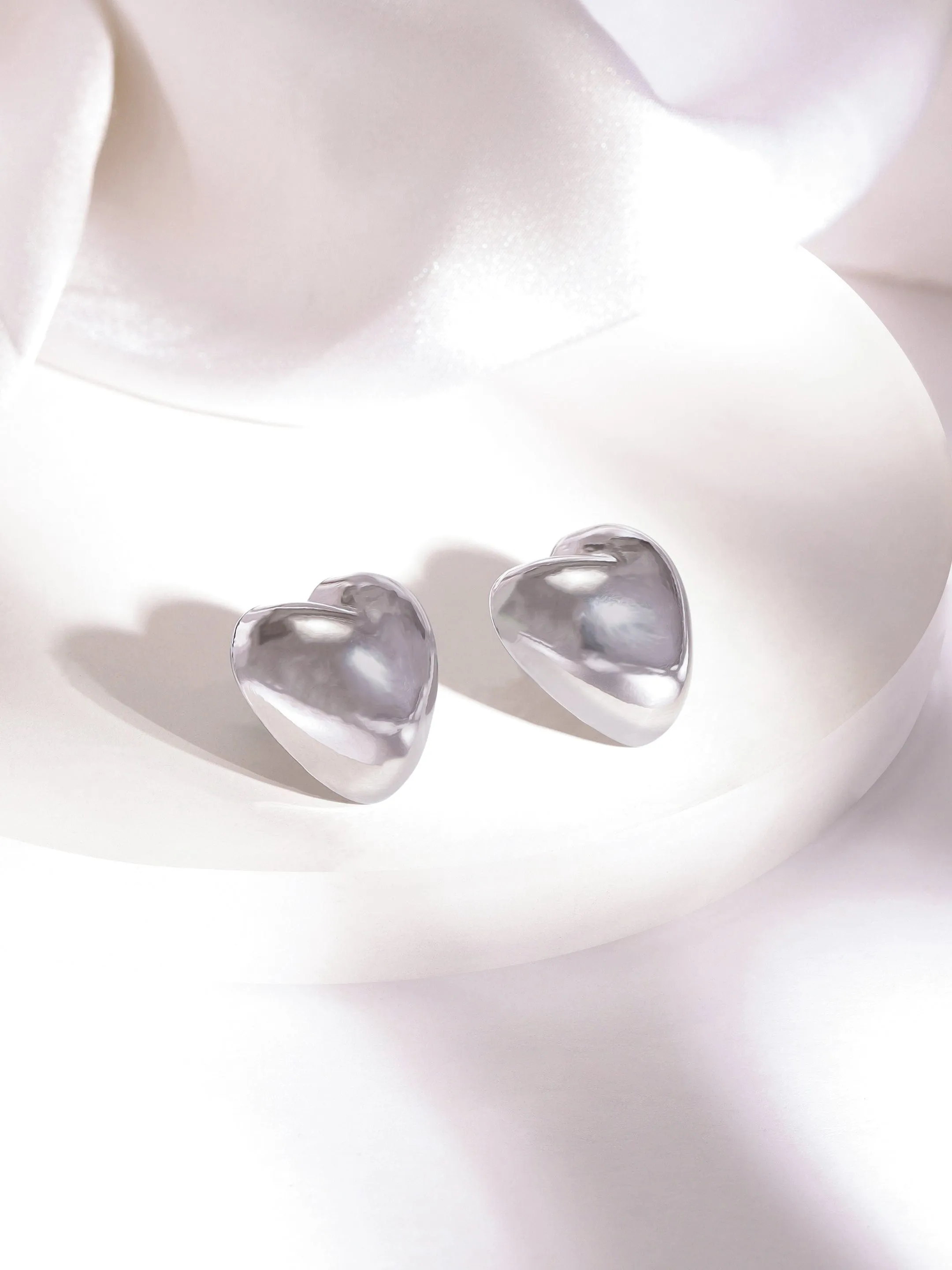 Rubans Rhodium Plated Heart Shaped Stud Earrings with Sleek Silver Tone Finish